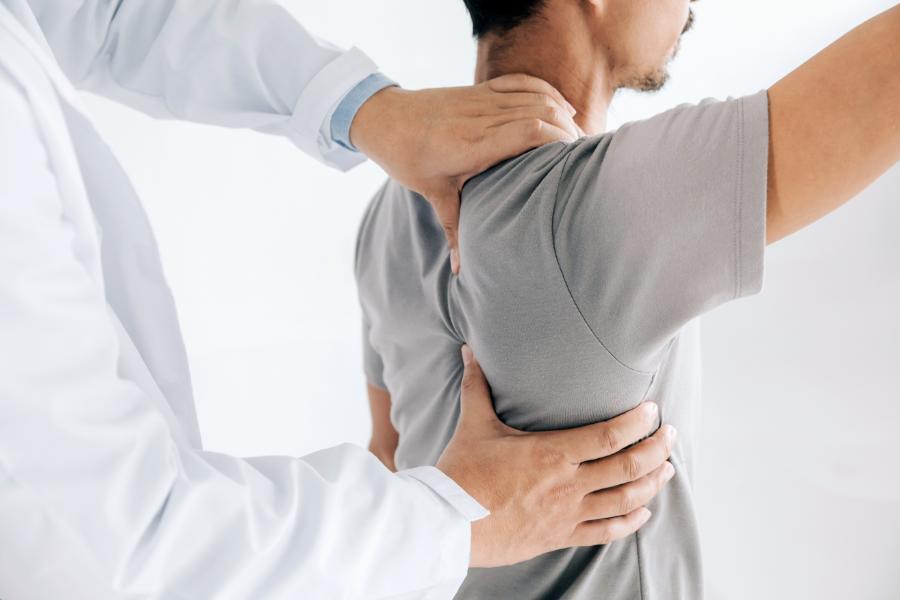physiotherapist doing healing treatment on man's back